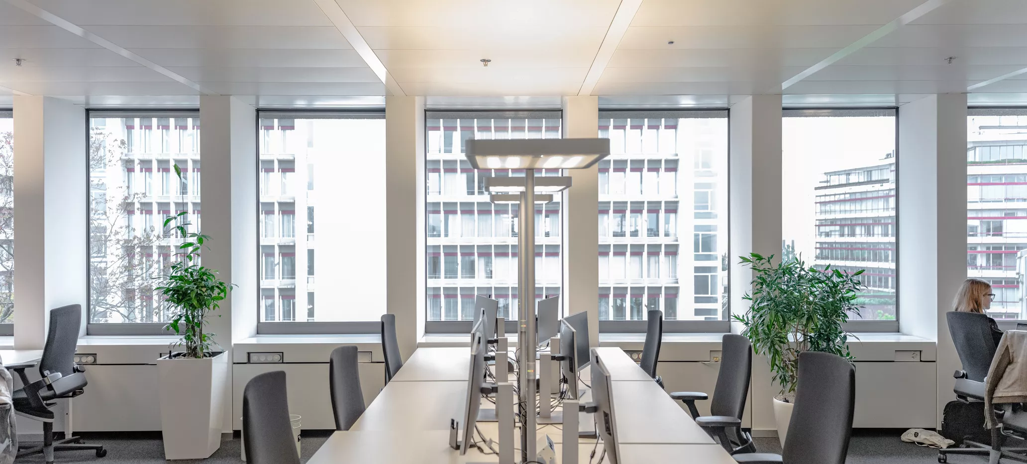 Desk spaces in Building 210, with the view from the large windows in the background